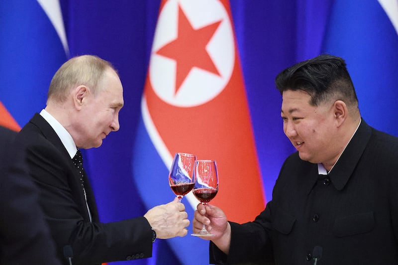 Russia’s President Vladimir Putin and North Korean leader Kim Jong Un toast during a reception in Pyongyang on June 19, 2024.