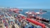 FILE - Shipping containers and gantry cranes are seen at a port in Lianyungang, in eastern China's Jiangsu province, on Aug. 7, 2024.