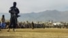 FILE - Taliban security personnel stand guard as people watch a public flogging at a stadium in Charikar, Parwan province, Afghanistan, on Dec. 8, 2022. Four people, including a woman, were similarly flogged recently, Taliban officials said on Oct. 29, 2024.