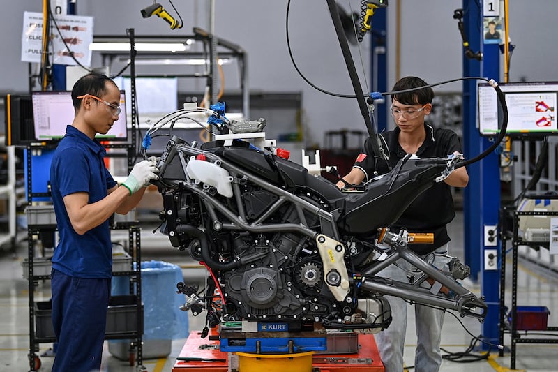 Workers assemble a motorbike at the Northstar Precision Vietnam factory in Vinh Phuc province, Aug. 30, 2023.