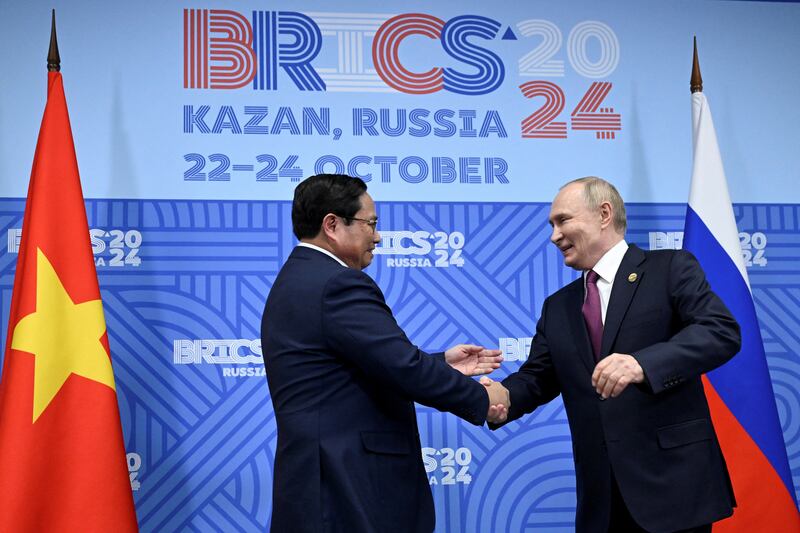 Russian President Vladimir Putin shakes hands with Vietnamese Prime Minister Pham Minh Chinh during a meeting on the sidelines of the BRICS summit in Kazan, Russia Oct. 24, 2024.